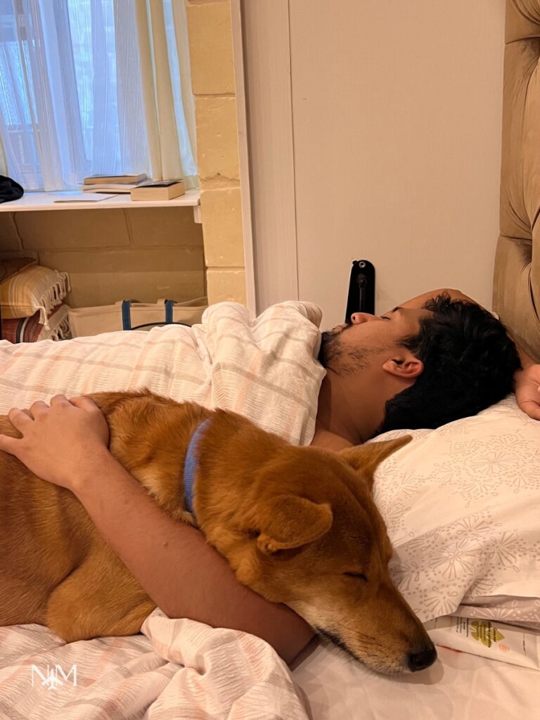 Sean having a nap and the dog is also snuggled up with him